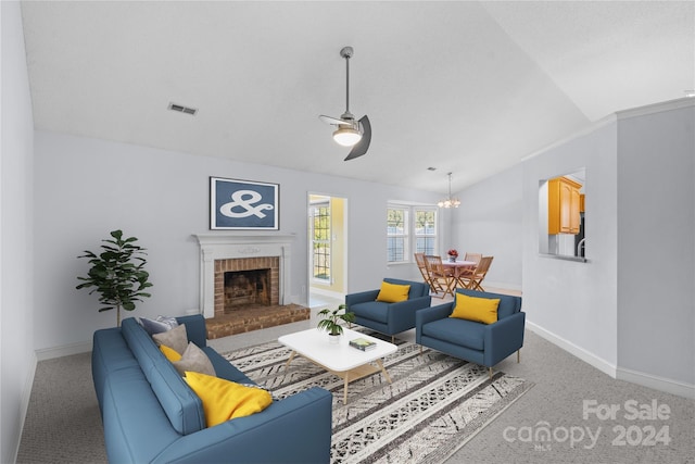 living room featuring carpet, ceiling fan with notable chandelier, a fireplace, and vaulted ceiling