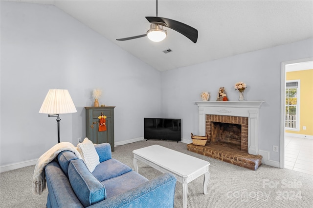 carpeted living room with vaulted ceiling, a fireplace, and ceiling fan