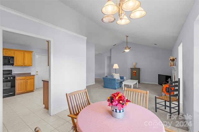 tiled dining area with lofted ceiling and ceiling fan with notable chandelier