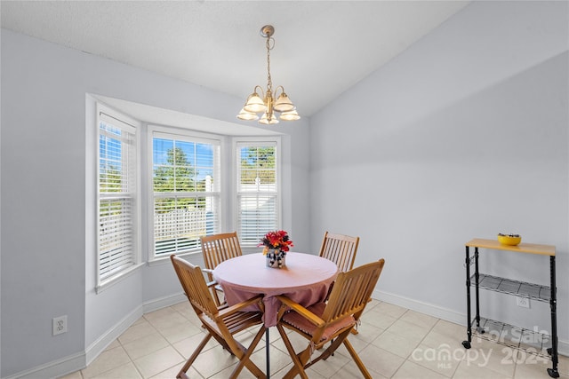 dining room featuring a notable chandelier and light tile patterned flooring