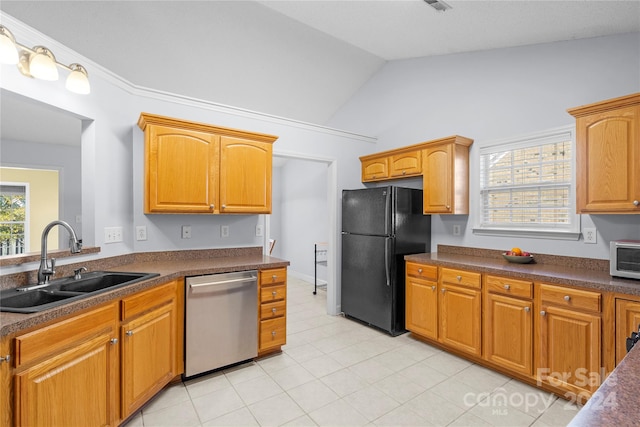 kitchen featuring sink, light tile patterned flooring, dishwasher, black fridge, and lofted ceiling