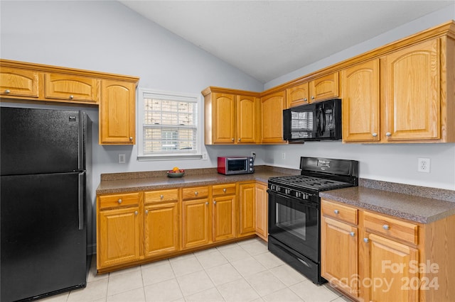 kitchen featuring black appliances and vaulted ceiling