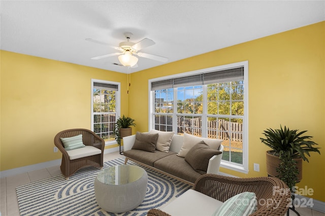 tiled living room with plenty of natural light and ceiling fan