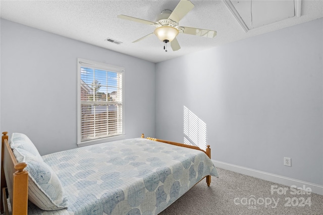 bedroom featuring a textured ceiling, carpet, and ceiling fan