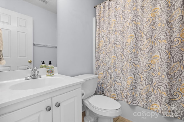 full bathroom featuring vanity, shower / bath combo, a textured ceiling, and toilet