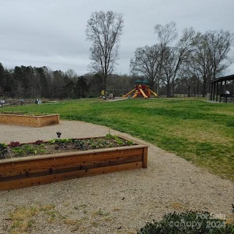 view of property's community with a yard and a playground