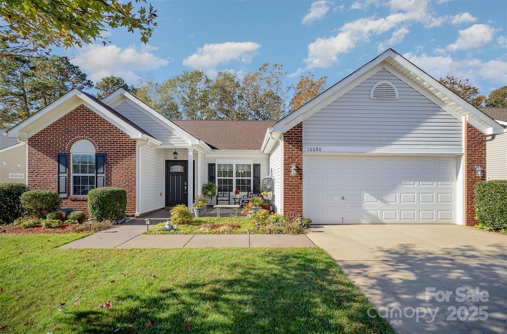 ranch-style home featuring a garage and a front lawn