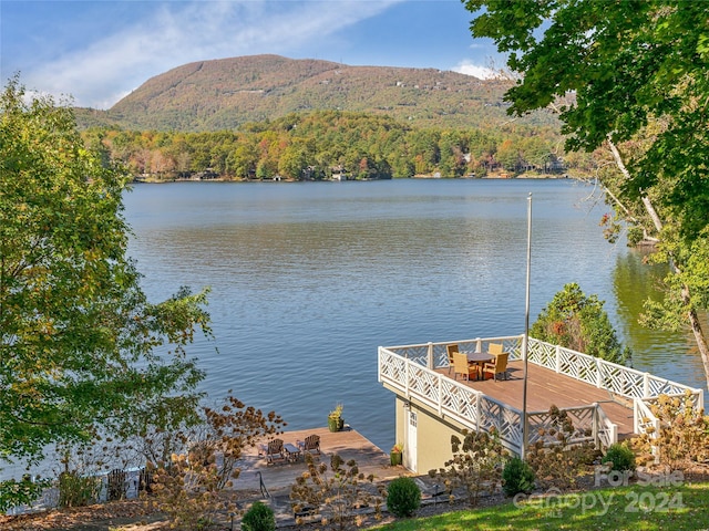 view of dock with a water and mountain view