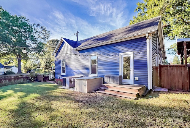 back of property featuring a lawn