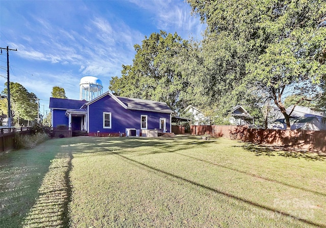 rear view of house featuring a lawn