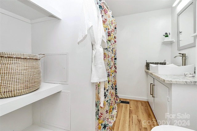 bathroom featuring vanity and hardwood / wood-style flooring