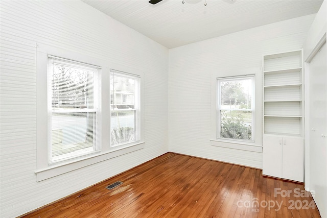 empty room with ceiling fan and wood-type flooring