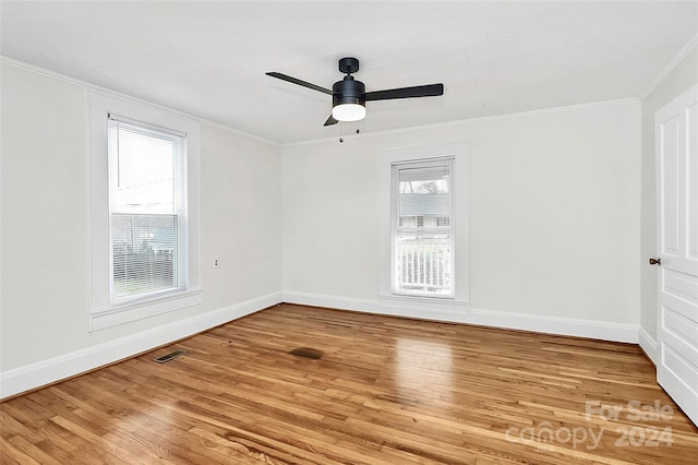 unfurnished room with hardwood / wood-style flooring, ceiling fan, a healthy amount of sunlight, and ornamental molding