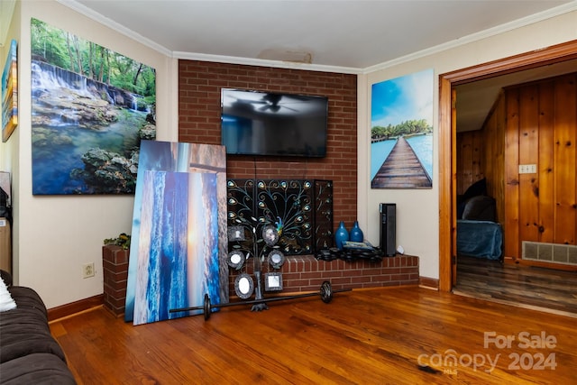 living room with hardwood / wood-style flooring and crown molding