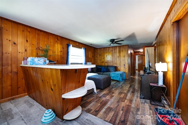 bar with wood walls, dark hardwood / wood-style floors, and ceiling fan