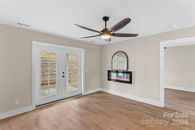 unfurnished room featuring ceiling fan, hardwood / wood-style floors, and french doors