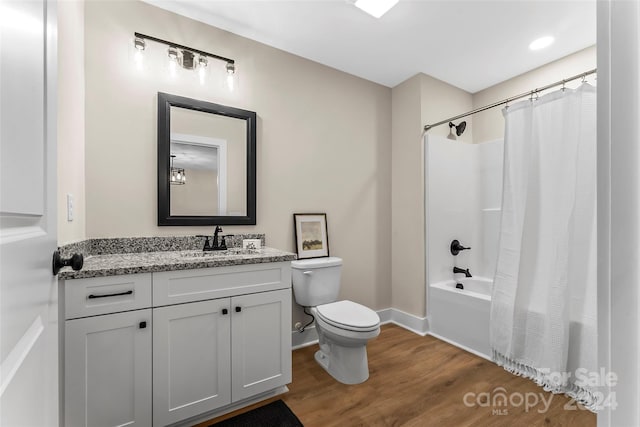 full bathroom with wood-type flooring, vanity, toilet, and shower / bathtub combination with curtain