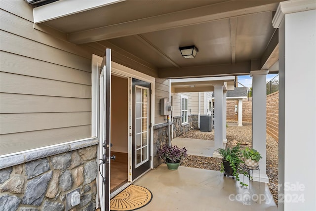 entrance to property featuring a patio and central AC unit