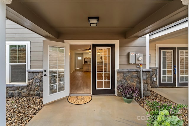 property entrance with a patio and french doors