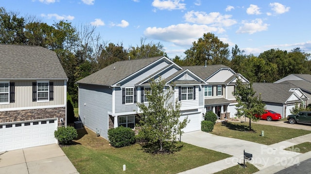 view of front of house featuring a garage and a front yard