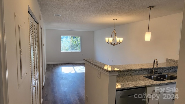 kitchen featuring light stone counters, stainless steel dishwasher, dark wood-type flooring, sink, and pendant lighting