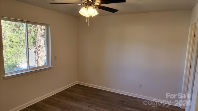 spare room with ceiling fan and dark wood-type flooring