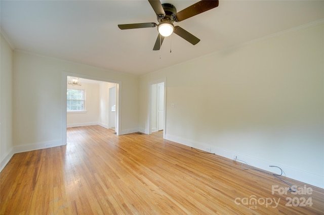 empty room with ornamental molding, ceiling fan, and light hardwood / wood-style flooring