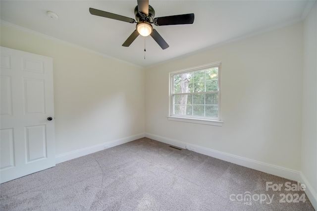 spare room with ceiling fan, ornamental molding, and carpet flooring