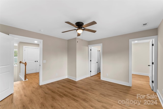 spare room featuring ceiling fan and light hardwood / wood-style flooring