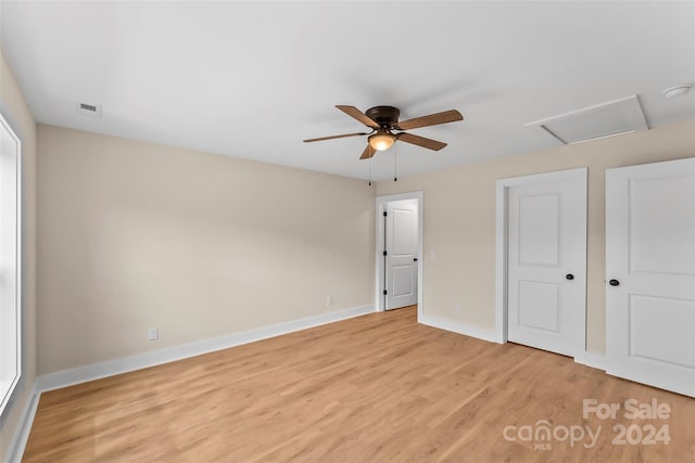 unfurnished bedroom with ceiling fan and light wood-type flooring