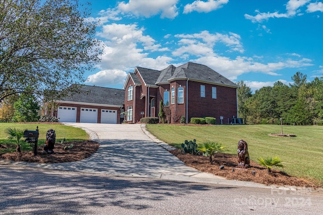 front of property featuring a front lawn and a garage