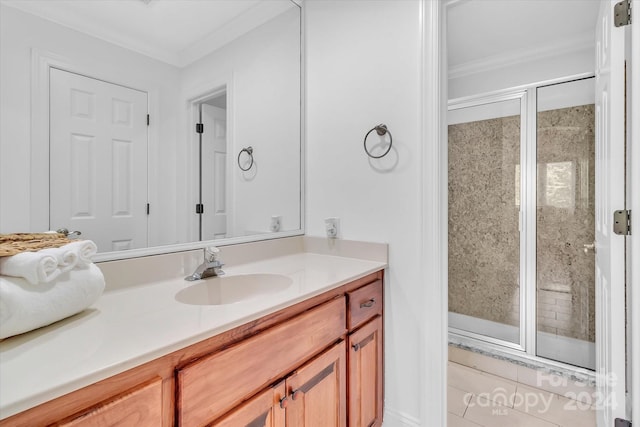 bathroom featuring tile patterned flooring, an enclosed shower, crown molding, and vanity