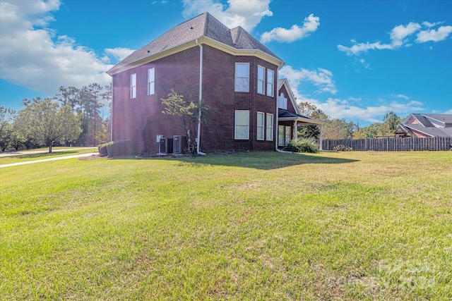 view of home's exterior featuring central AC and a lawn