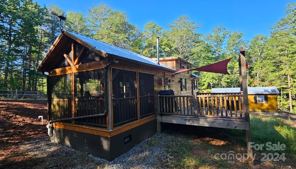 wooden deck with a sunroom