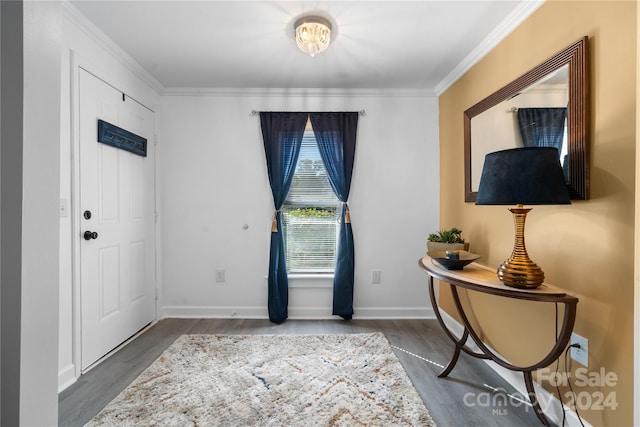 foyer featuring ornamental molding and dark hardwood / wood-style flooring