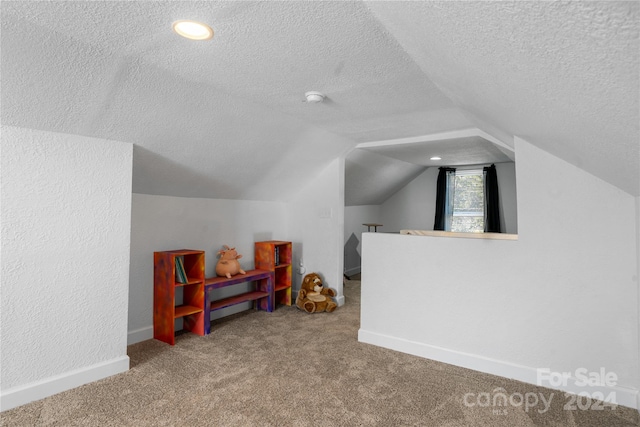 bonus room featuring carpet flooring, a textured ceiling, and lofted ceiling