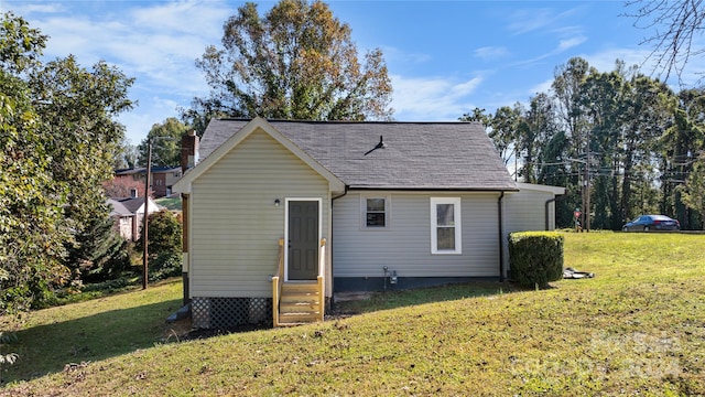 back of property featuring a lawn