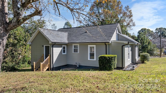 back of property featuring a lawn