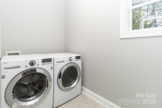 laundry area featuring separate washer and dryer and light tile patterned floors