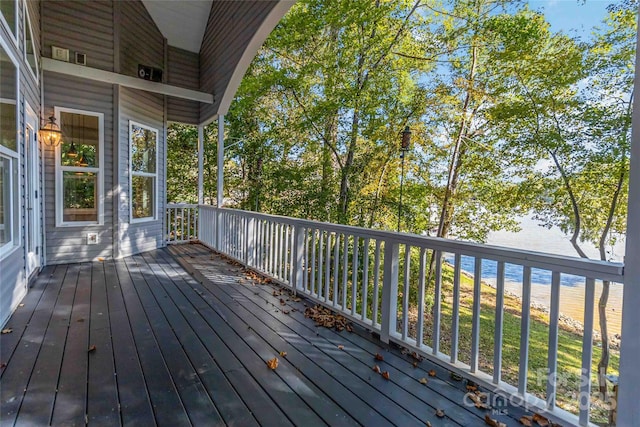 wooden deck featuring a water view