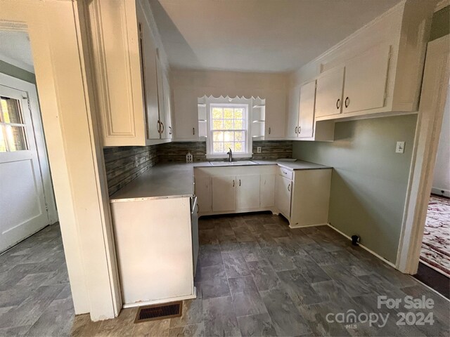 704 Mcadenville Rd, Lowell, NC 28098 - kitchen with a sink, tasteful backsplash, white cabinetry, and light countertops