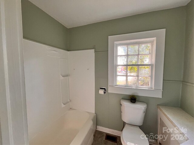 704 Mcadenville Rd, Lowell, NC 28098 - full bath featuring toilet, baseboards, and shower / bath combination