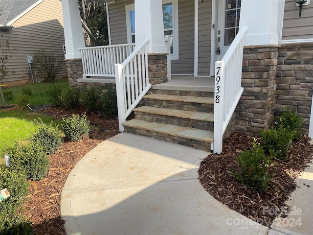 view of exterior entry with a porch