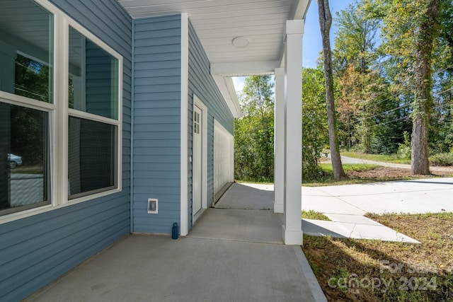 view of patio featuring a garage and covered porch