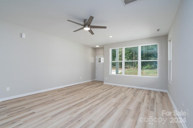 unfurnished room featuring light hardwood / wood-style floors and ceiling fan