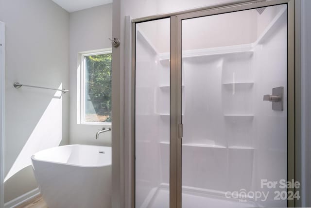 bathroom with shower with separate bathtub