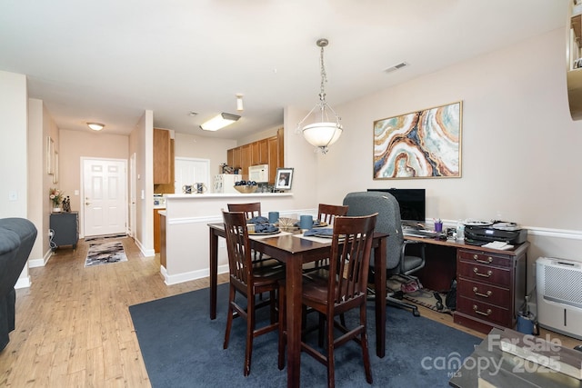 dining space featuring light wood-type flooring