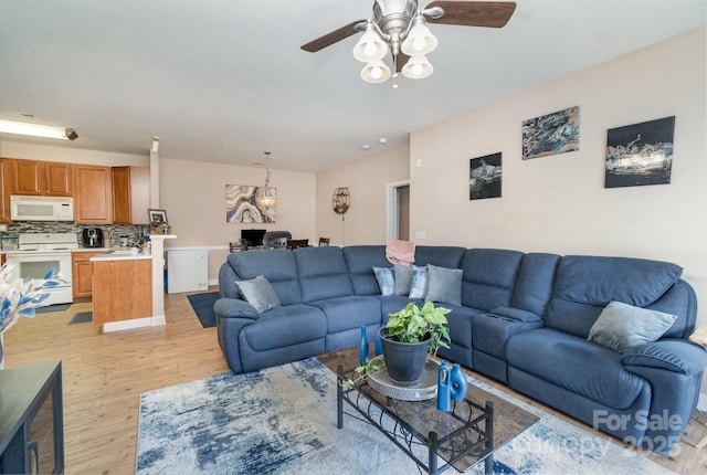 living room featuring ceiling fan and light hardwood / wood-style floors