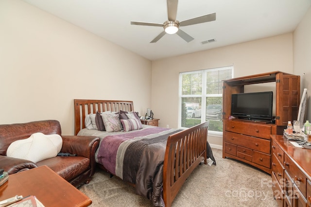 bedroom with ceiling fan and light colored carpet