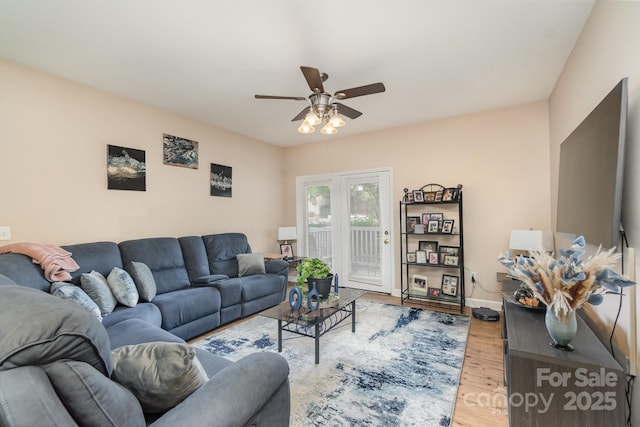 living room with hardwood / wood-style floors and ceiling fan